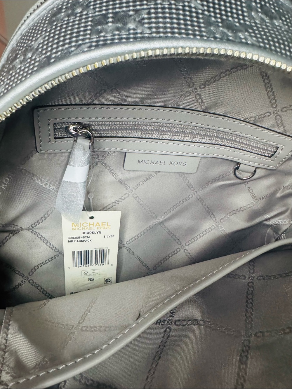 Michael Kors Metallic Silver MK Embossed Logo Backpack - Picture 8 of 9